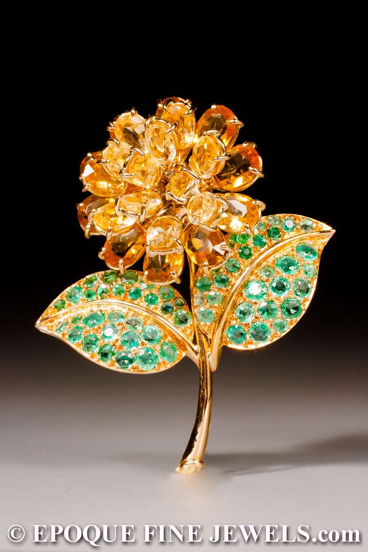 An 18 karat yellow gold , citrine and emerald flower brooch